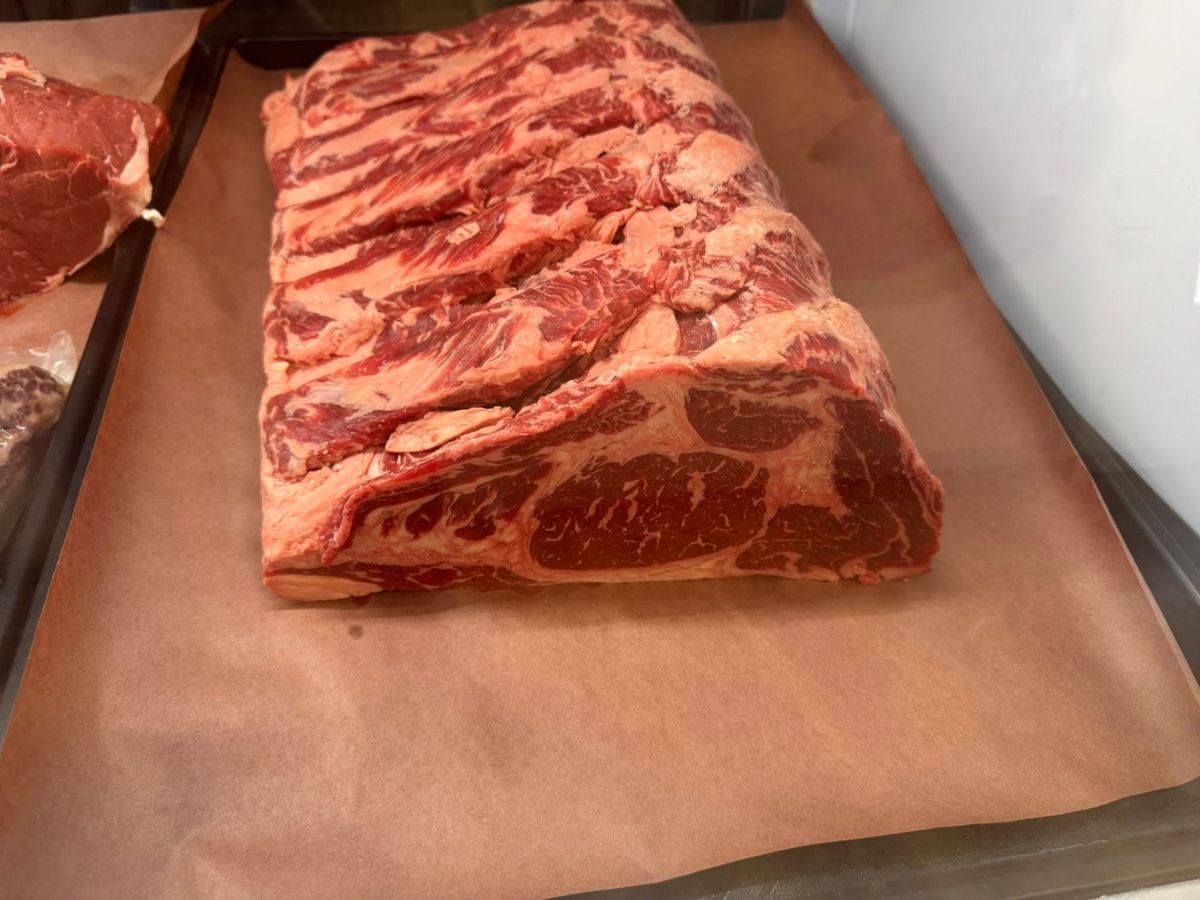 A well-marbled rib eye roast from Max Farms Butcher Shop, ready for the case